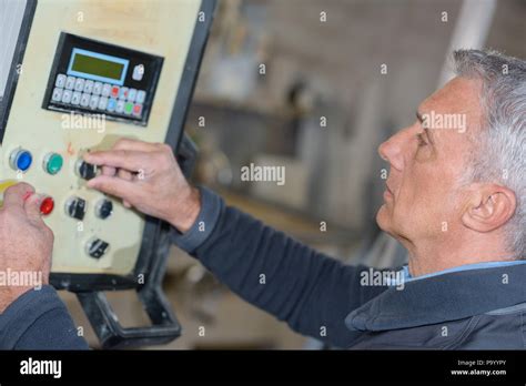 Worker In Factory Using Machine Stock Photo Alamy