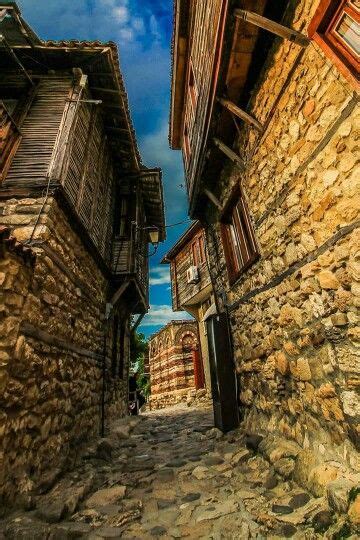 An Alley Way With Stone Buildings And Cobblestones