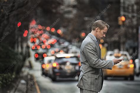 A Man Checking His Cell Phone On A Street Stock Image F009 2334