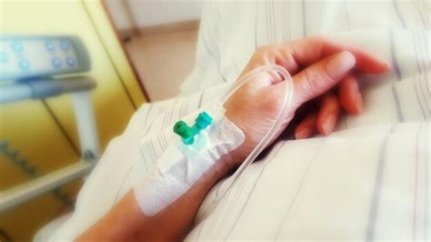 Premium Photo Cropped Hand Of Woman With Iv Drip On Bed In Hospital