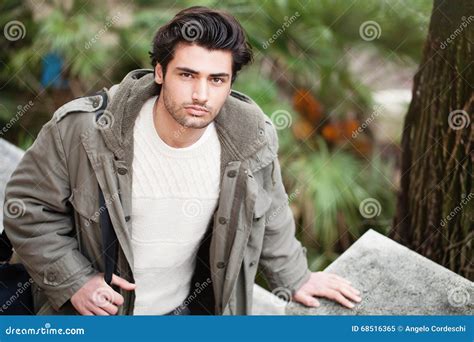 Handsome Young Italian Man Stylish Hair And Coat Outdoors Stock Image