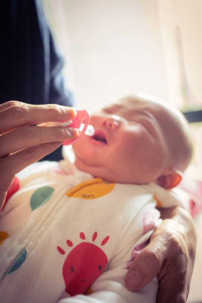 60+ Crying Baby Pacifier Looking Stock Photos, Pictures & Royalty-Free ...