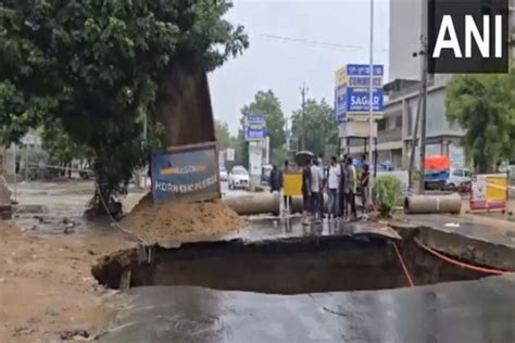 As Road Caves In During Heavy Rain Massive Sinkhole Created In