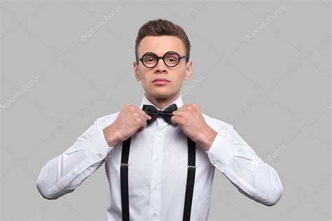 Serious Young Nerd Man Adjusting His Bow Tie Stock Photo By