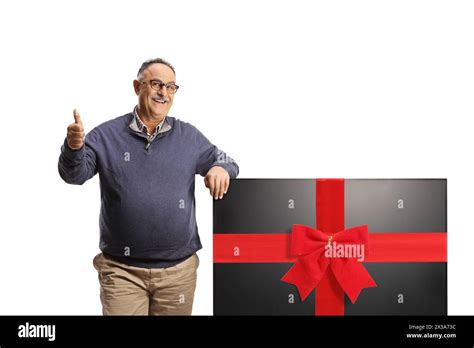 Mature Man Leaning On A New Flat Lcd Tv Screen And Gesturing Thumbs Up