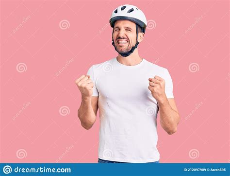 Young Handsome Man Wearing Bike Helmet Excited For Success With Arms