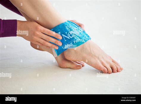 Woman Using A Hot Cold Gel Pack Treatment To Releive Pain Stock Photo Alamy