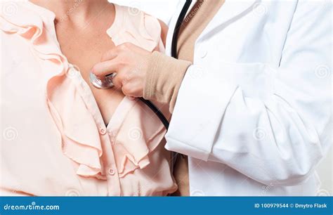 Female Doctor Listening To Patients Chest With Stethoscope Checking