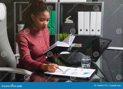 Young African American Businesswoman Working With Documents And