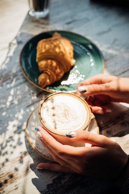 Premium Photo Cappuccino And Croissant On The Table In The Cafe The