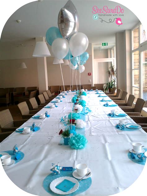 The Table Is Set With Blue And White Decorations Silver Balloons And