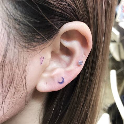 Tiny Crescent Moon And Letter V Tattoos Located On