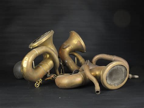 Bonhams Cars : A group of four small brass horns,