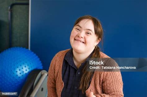 Ein Mädchen Mit Downsyndrom Sitzt Lächelnd Da Stockfoto Und Mehr Bilder