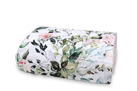 Premium Photo | A white floral comforter with a floral pattern on it.