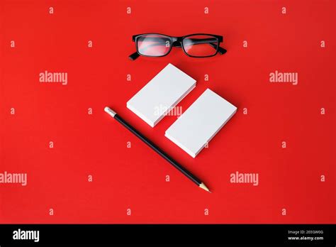 Blank Business Cards Pencil And Glasses On Red Paper Background