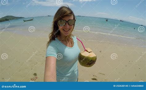 Selfie Smiling Female Traveler Walks Around Beach And Drinks Out Of A