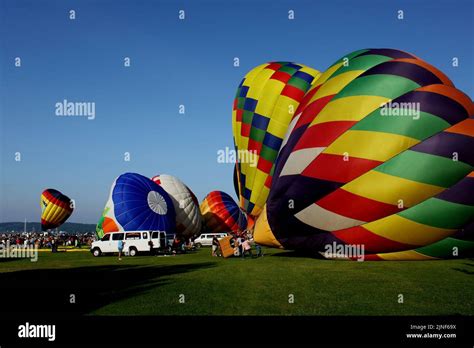 People Blowing Up Balloons At A Hot Air Balloon Festival In Travers