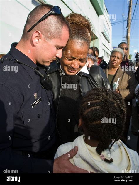 Oakland Police Officer Tim Scarrott Comforts Denise Cusseaux Vital