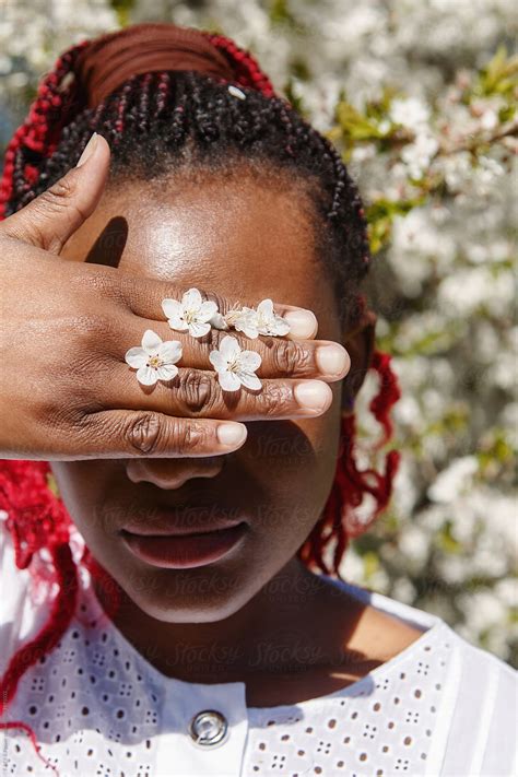 "Black Woman Holding Hand With Flowers Near Eyes" by Stocksy ...