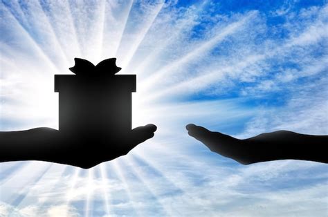 Premium Photo Altruism Silhouette Of A Hand Giving A Gift And A Hand