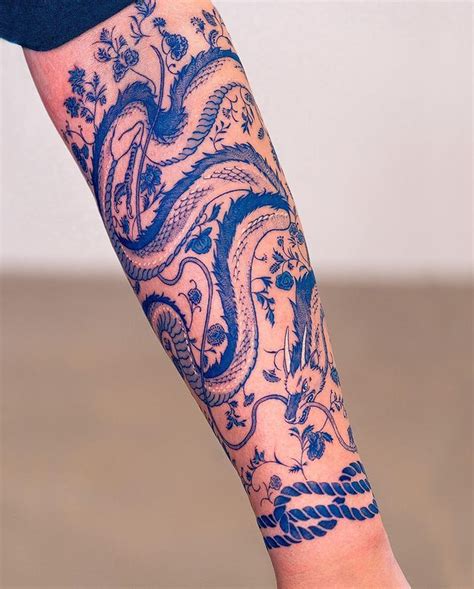 A Person With A Tattoo On Their Arm