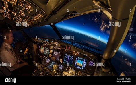 Pilot At Work Inside Modern Jet Passenger Airliner Flight Deck