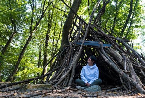 Premium Photo | Woman survivalist in a campsite in the forest special shelter refuge camp