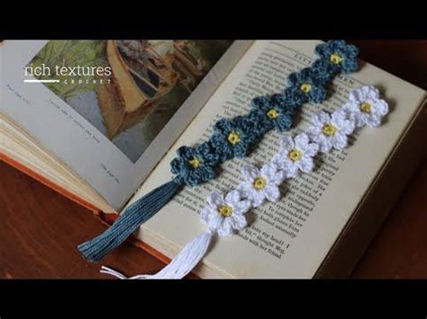 An Open Book With Crocheted Flowers And Tassels