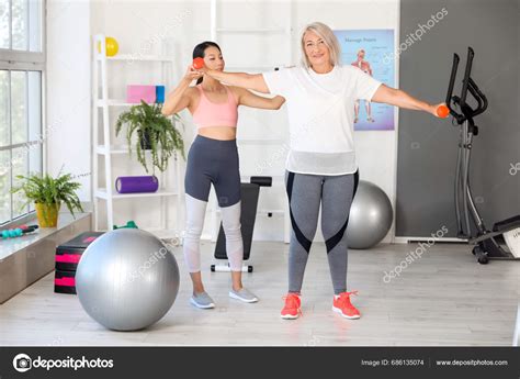 Mature Woman Training Dumbbells Therapist Rehabilitation Center Stock