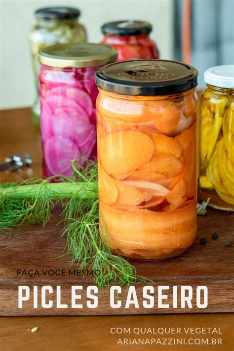 Jars Filled With Pickled Vegetables Sitting On Top Of A Wooden Table