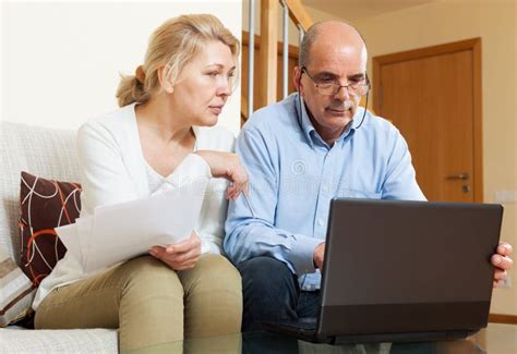Senior Man With Mature Wife Reading Business Documents Stock Image