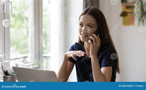 Happy Freelance Worker Woman Answering Telephone Call In Home Office