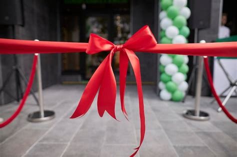 Premium Photo Red Ribbon Bow At The Store Opening Event In