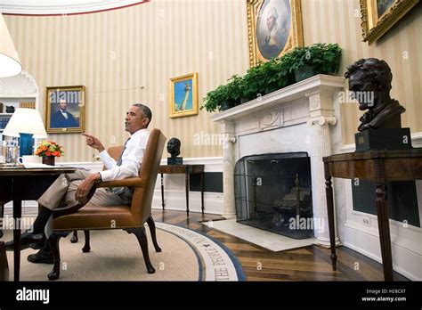 U S President Barack Obama Sits At His Desk During A Meeting In The