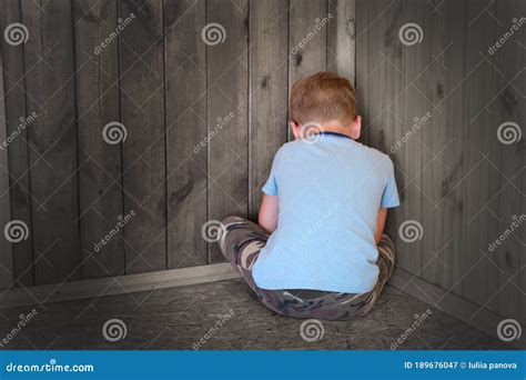 Sad Little Boy Sitting In The Corner Turned His Back Stock Image