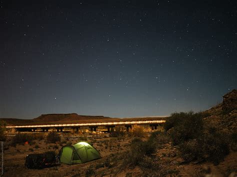 Camping In Moroccan Desert Near Bridge Enlightened By The Passing Car