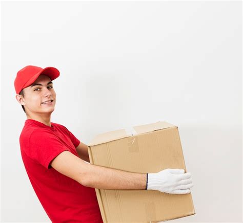 Free Photo Smiley Delivery Man Carrying Package