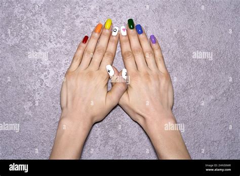Hands With LGBT Rainbow Flag And Rose Triangle Manicure Symbol Of Lesbian Gay Bisexual