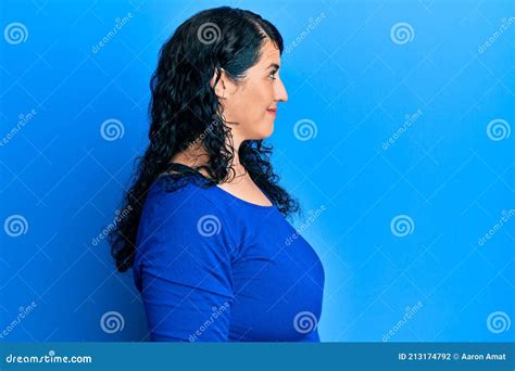 Plus Size Brunette Woman Wearing Casual Blue Shirt Looking To Side Relax Profile Pose With