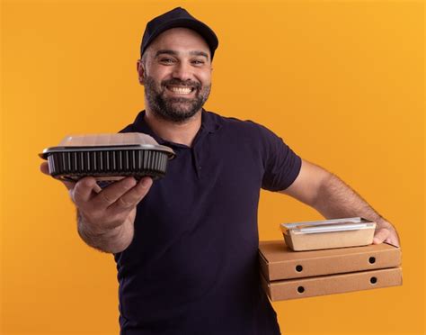 Free Photo Smiling Middle Aged Delivery Man In Uniform And Cap