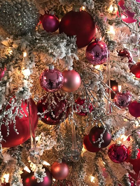 The Christmas Tree Is Decorated With Red And Silver Ornaments