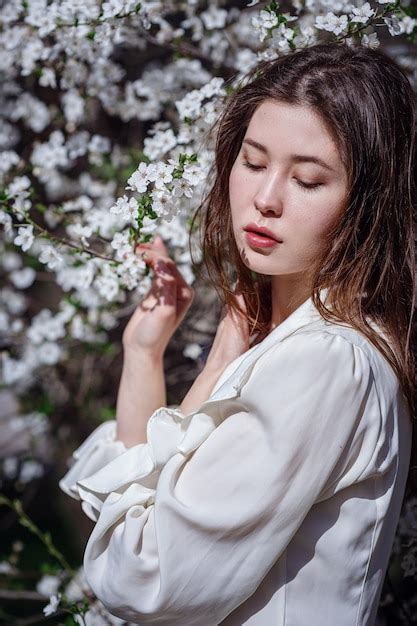 Premium Photo Young Asian Woman In A Flowering Garden Romantic Image