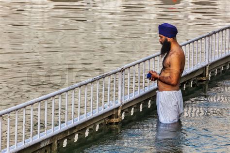 Sikh Man Praying And Bathing In Holy Tank Around Harmandir Sahi Stock