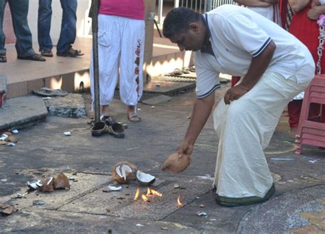 Breaking Coconut At A Quiet Thaipusam Ceremony In Georgetown Penang