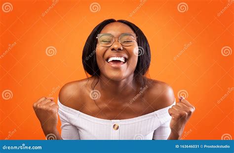 Excited African American Lady Gesturing Yes Standing Over Orange