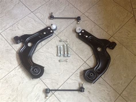 FORD PUMA 97 01 TWO FRONT LOWER WISHBONE SUSPENSION ARMS 6 BOLTS AND 2