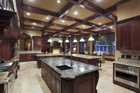 A Large Kitchen With Marble Counter Tops And Dark Wood Cabinets Along