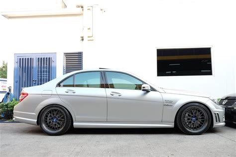 A White Car Parked In Front Of A Building