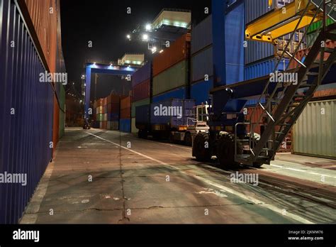 operation of container terminal at night. Unloading container ship at ...